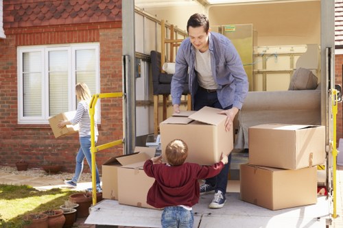 Careful unpacking of kitchen boxes in a Bermondsey home
